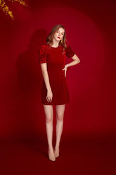 Velvet mini dress with puff sleeves and tailored silhouette for refined festive styling